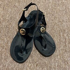Michael Kors Glossy Black Sandals with Gold Emblem
